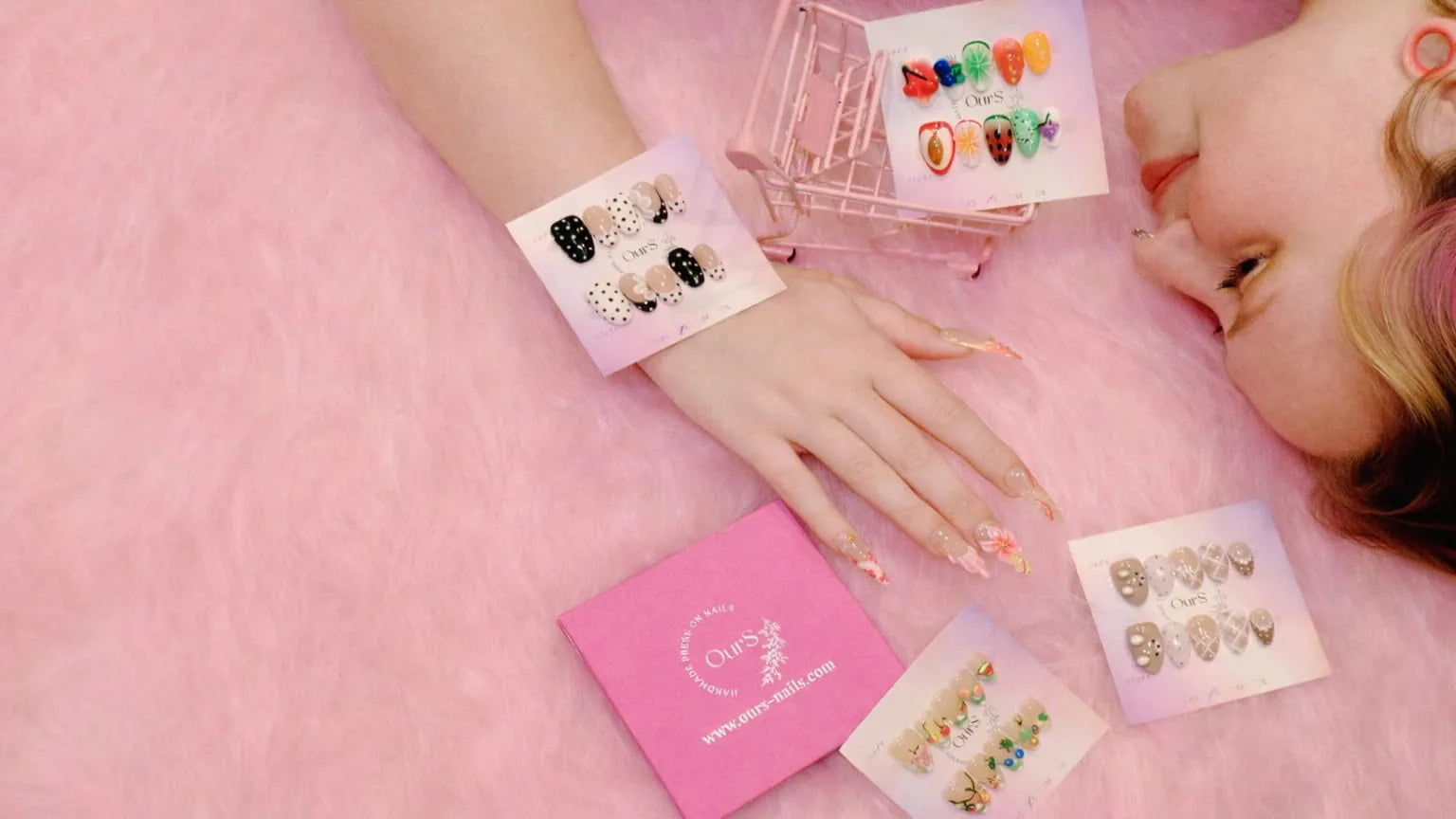 Person showcasing hand-painted press-on nails